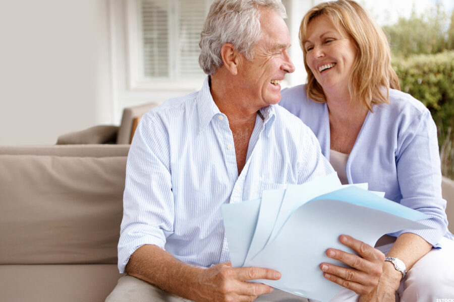 Senior couple reading over some documents on the porch